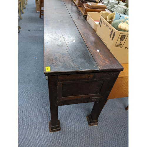 408 - A Georgian oak dresser base having three drawers with brass swan neck handles and on squared cut-dow... 