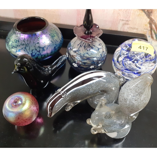 417 - A small quantity of glass paperweights to include Langham together with a purple iridescent bowl in ... 