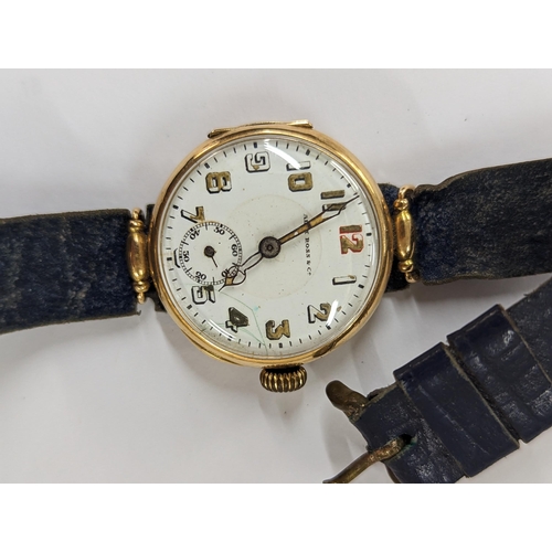 423 - An early 20th century trench watch A/F stamped 14K having a white enamel dial inscribed Alex Ross & ... 