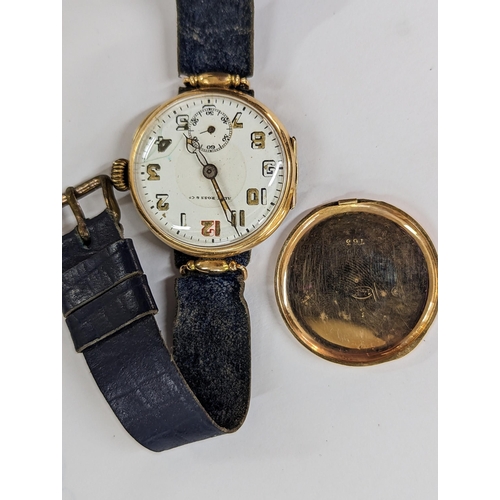 423 - An early 20th century trench watch A/F stamped 14K having a white enamel dial inscribed Alex Ross & ... 