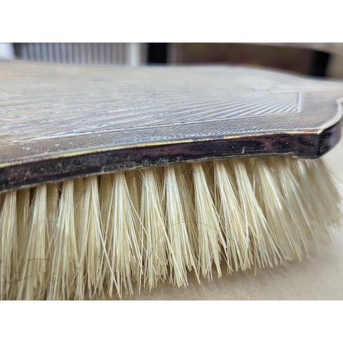 429 - A boxed silver mounted dressing table brushes and comb set, along with a cased set of silver handled... 