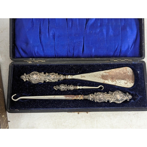 429 - A boxed silver mounted dressing table brushes and comb set, along with a cased set of silver handled... 