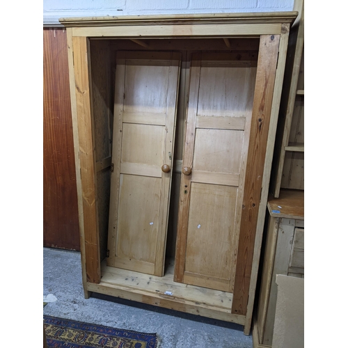 270 - A 19th century and later pine two door wardrobe having panelled doors and block shaped feet, 190cm h... 