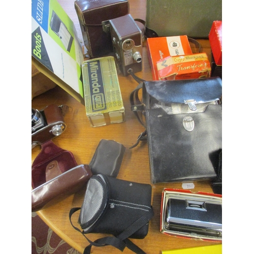 65 - A mixed lot of film cameras and accessories, 3-D Viewmaster, projectors, and other items to include ... 