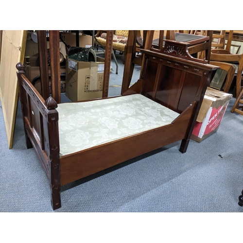 274 - A Victorian mahogany child's bed having carved pierced decoration and on block shaped legs, 65cm h x... 