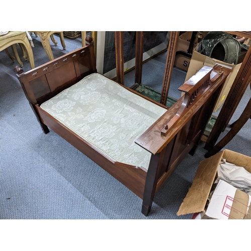 274 - A Victorian mahogany child's bed having carved pierced decoration and on block shaped legs, 65cm h x... 