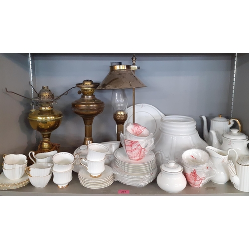 201 - Three oil lamps, one milk glass shade and mixed ceramics to include Royal Doulton Carnation tea ware... 