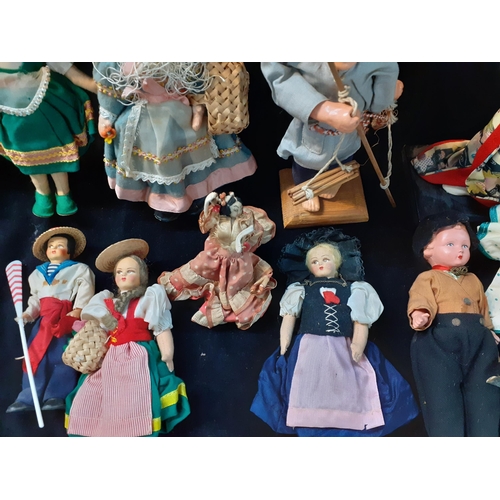 295 - Dolls of the World to include mid 20th century fabric examples, all housed in a small hamper basket ... 