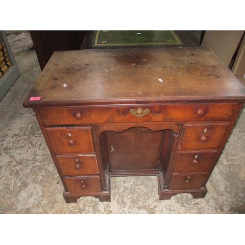 85 - A late Georgian mahogany lowboy with central hutch cupboard flanked by six short drawers below one l... 