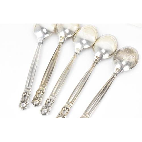 10 - A boxed set of nine Danish silver teaspoons by Georg Jensen, designed by Johan Rodhe, in the acorn p... 