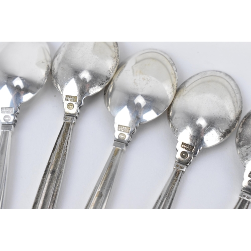 10 - A boxed set of nine Danish silver teaspoons by Georg Jensen, designed by Johan Rodhe, in the acorn p... 