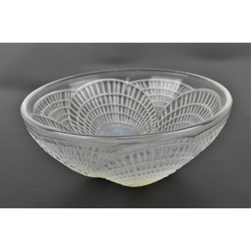 12 - A Lalique 'Coquille' pattern iridescent bowl, of circular form with four relief shells, the undersid... 