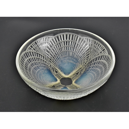 12 - A Lalique 'Coquille' pattern iridescent bowl, of circular form with four relief shells, the undersid... 