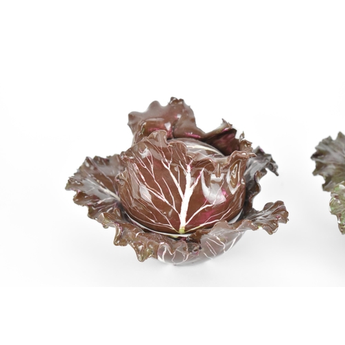 27 - A pair of studio ceramic trompe l'oeil cabbage pots, each realistically rendered, with painted insec... 