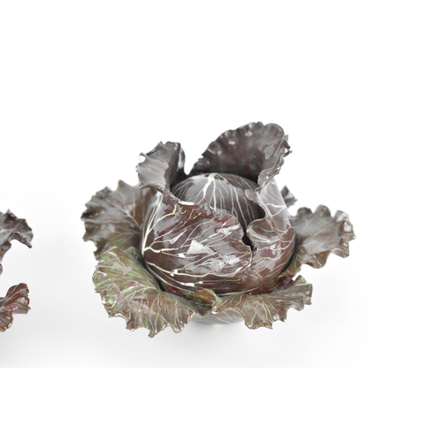 27 - A pair of studio ceramic trompe l'oeil cabbage pots, each realistically rendered, with painted insec... 