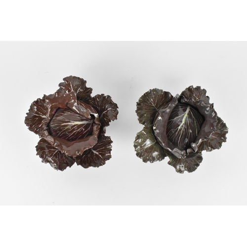 27 - A pair of studio ceramic trompe l'oeil cabbage pots, each realistically rendered, with painted insec... 