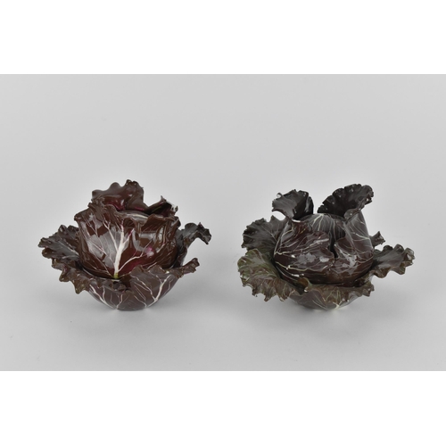 27 - A pair of studio ceramic trompe l'oeil cabbage pots, each realistically rendered, with painted insec... 