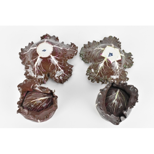 27 - A pair of studio ceramic trompe l'oeil cabbage pots, each realistically rendered, with painted insec... 