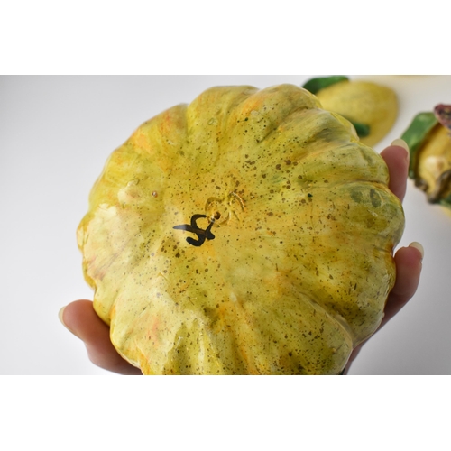 36 - A small collection of studio ceramic trompe l'oeil vegetables, comprising an apple and lemon as lidd... 