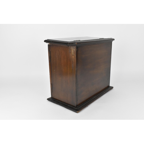 44 - An Art Nouveau mahogany smokers cabinet, the front hinged doors with marquetry panels of stylised tu... 