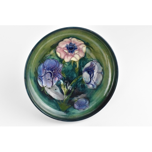 50 - An early 20th century Walter Moorcroft pottery footed bowl, in the blue 'anemone' pattern, 16 cm dia... 