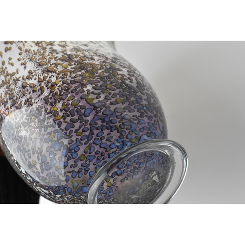 54 - A hand blown studio glass vase by Dan Aston, with everted rim and speckled lilac body, the underside... 