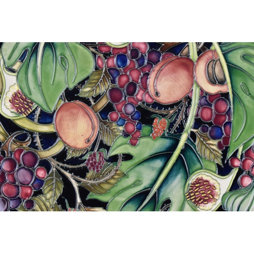 59 - A Moorcroft pottery charger designed by Emma Bossons, in the 'Queen's Choice' pattern, of circular f... 