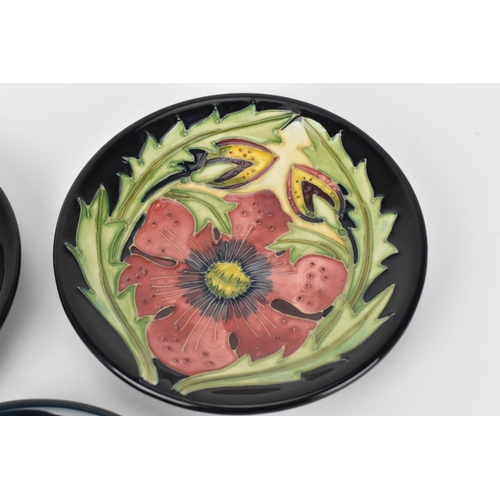 62 - Three Moorcroft pottery pin dishes by various artists, to include Rachel Bishop in the 'Pansies' pat... 