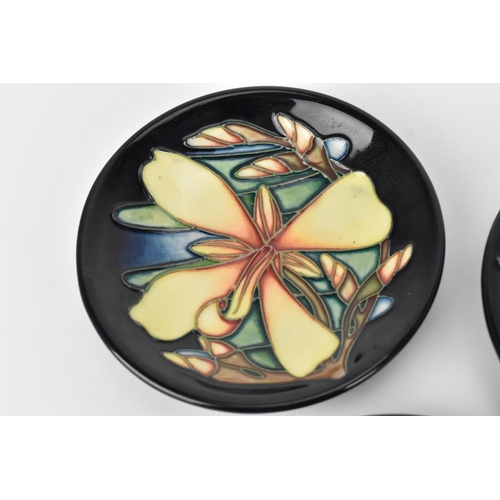 62 - Three Moorcroft pottery pin dishes by various artists, to include Rachel Bishop in the 'Pansies' pat... 