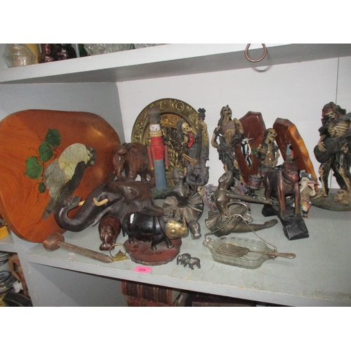 234 - A mixed lot of composition, wooden and metal figurines, animal models, and other items to include a ... 