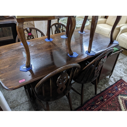 254 - A mid-century refectory dining table, 72cm x 138cm x 71cm, and four Ercol style wheel back chairs
Lo... 