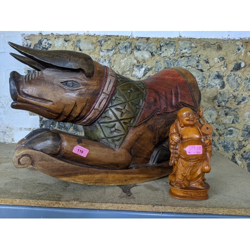 119 - A modern Indonesian carved wooden rocking pig and a Chinese hardwood figure
Location:G