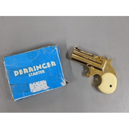 124 - A Derringer 6mm Starter Pistol, in gilt metal, with original box
Location: CAB5