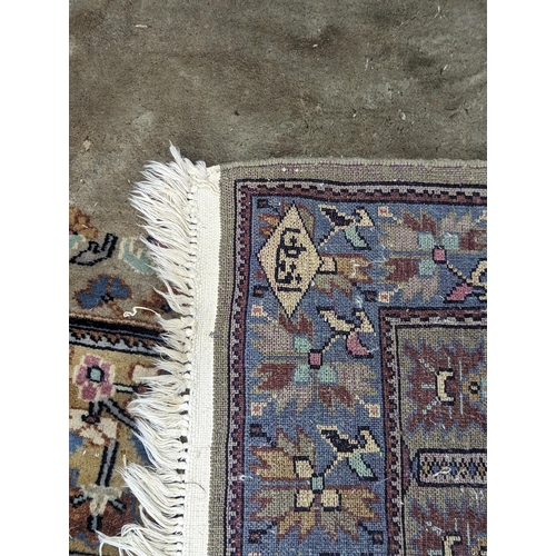 139 - A hand woven green ground Middle Eastern rug A/F having floral design repeating and tasselled ends 1... 