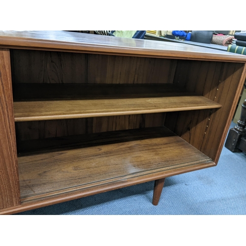 15 - A mid 20th century Gumi Omann for Axel Christensen, Denmark, teak sideboard having four sliding door... 