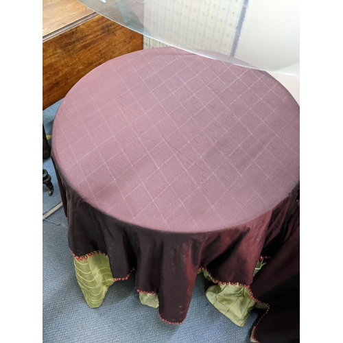 40 - A pair of purpose made circular tables having double layered table cloths comprising a lime silk pad... 