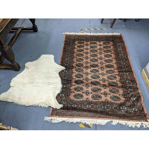 403 - A Middle Eastern handwoven rug having multiguard borders and repeating elephant foot motifs 186cm x ... 