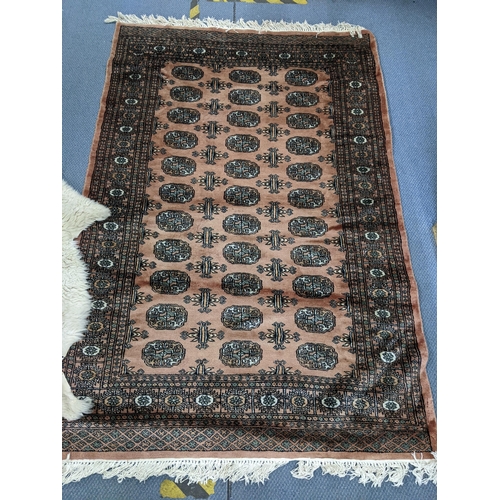 403 - A Middle Eastern handwoven rug having multiguard borders and repeating elephant foot motifs 186cm x ... 