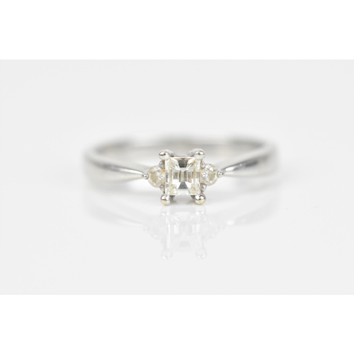 489 - An 18ct white gold and diamond engagement ring, with central princess style cut diamond with faceted... 