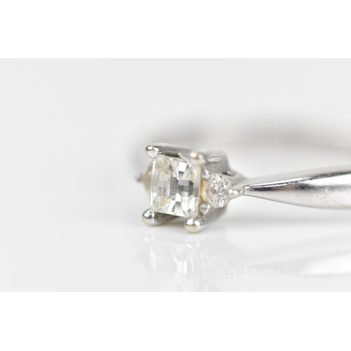 489 - An 18ct white gold and diamond engagement ring, with central princess style cut diamond with faceted... 