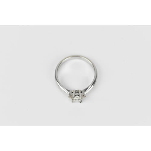 489 - An 18ct white gold and diamond engagement ring, with central princess style cut diamond with faceted... 