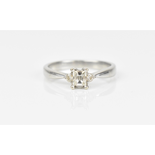 489 - An 18ct white gold and diamond engagement ring, with central princess style cut diamond with faceted... 