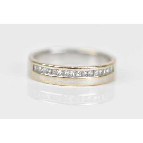 490 - An 18ct white gold and diamond wedding band, with a single row of princess cut channel set diamonds,... 