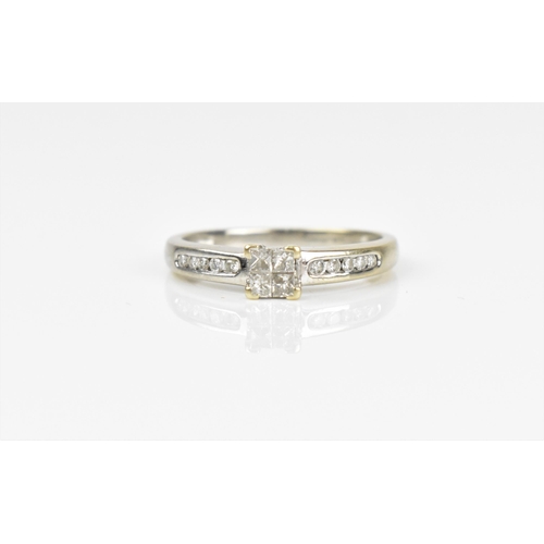 492 - An 18ct white gold and diamond engagement ring, with central four section diamond flanked with a row... 