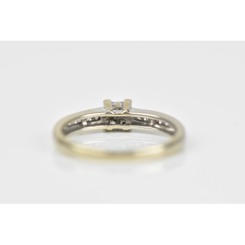 492 - An 18ct white gold and diamond engagement ring, with central four section diamond flanked with a row... 