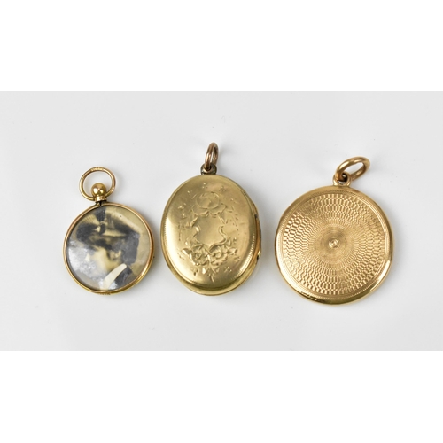 431 - A collection of three gold photo lockets, comprising a circular one with engine turned design, stamp... 