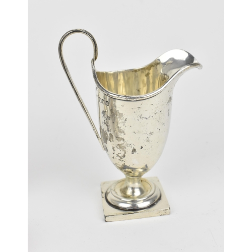 438 - A small collection of silver, to include an Edwardian silver milk jug, a pair of Victorian pepper po... 