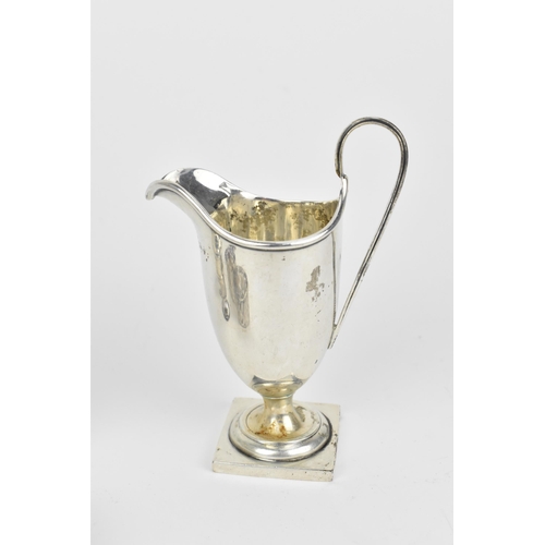 438 - A small collection of silver, to include an Edwardian silver milk jug, a pair of Victorian pepper po... 