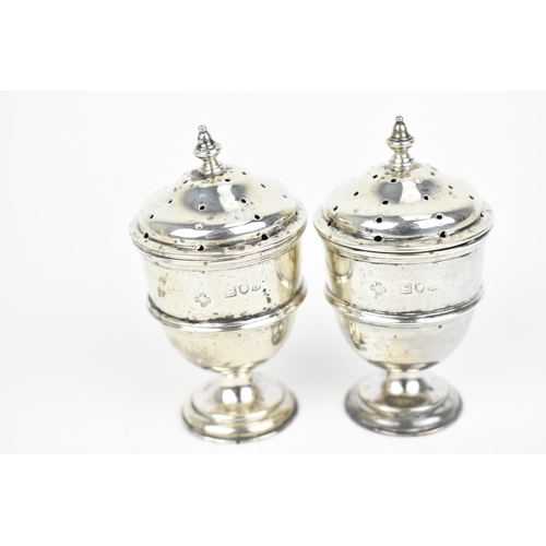 438 - A small collection of silver, to include an Edwardian silver milk jug, a pair of Victorian pepper po... 