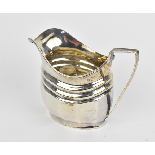 439 - A George III silver milk jug, London 1804, with reeded handle and faceted body, 8.6 cm high, weight ... 